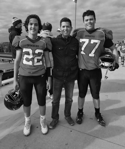 Tanio DeSouza accompanied by #22, his nephew Lucus DeSouza, and #77, his son Daniel DeSouza. Picture by Tanio’s daughter, Melissa, in Minot at the playoffs.
