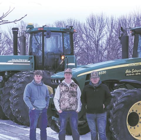 Ryan Corrik, Jaxon Wilson and Carlos Quezada stand with their tractors on Tractor Day. Submitted photo