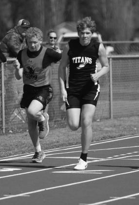 Samuel Kittleson, right, stays a step ahead of a runner from Rugby in the 100 meter dash.