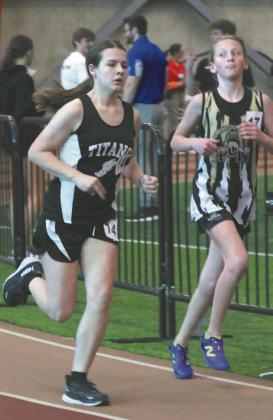Violet Hoyles passes a Pembina County North competitor in the girls 1500. Photo by Lyle Van Camp