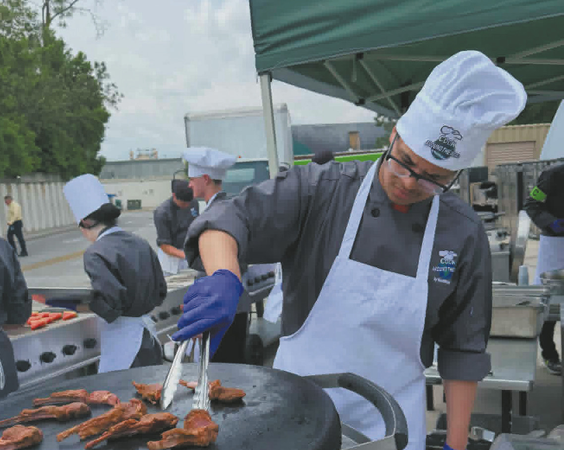 Jerimiah Johnson prepares lamb chops for his entree. Photo by Yvonne Johnson.