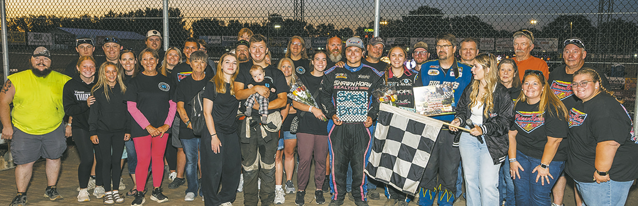 Friends and family surround Tucker, Joey and Kelsi Pederson during the Hall of Fame induction Friday, Aug. 7 at River Cities Speedway in Grand Forks. Photo by Robert Dusso, Dusso Photography