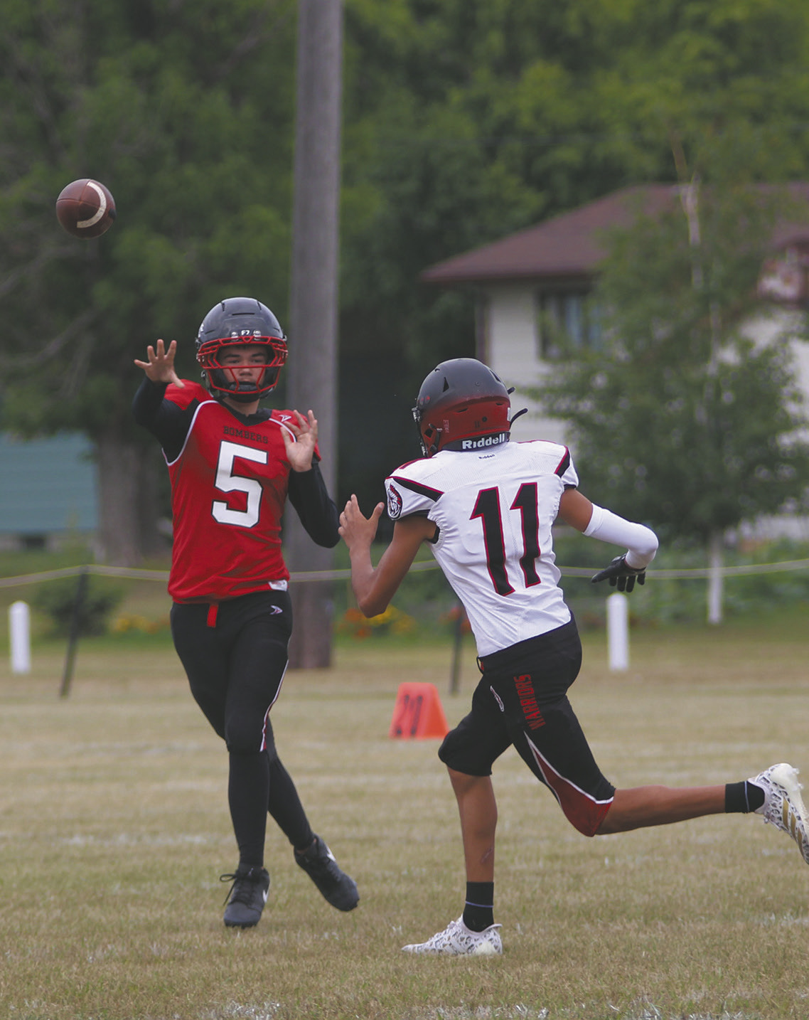 Senior quarterback Max Foss-Pokrzywinski gets the pass off over a White Shield defender. Photo by Jamie Rarick