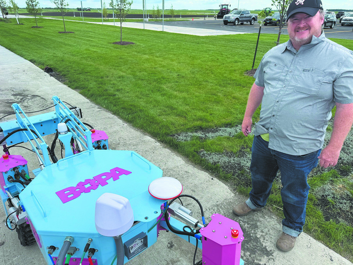 Grand Farm program manager David Vinson ready to take BOPA Precision Agriculture robot, the Autonomous Nano Tractor, out for testing. The robot tractors, used precision weeding and spraying on small and medium-sized farms, are just one of dozens of agtech products being tested at Grand Farm. Photo, Michael Standaert, NDNC.