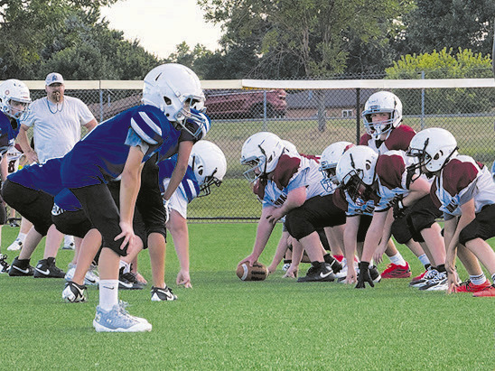 Bismarck Youth Football League teams the Cowboys (left) square off against the Cardinals in a pre-season scrimmage on the baseball outfield at Shiloh Christian School on Sept. 7, 2026. Photo, Michael Standaert, NDNC.