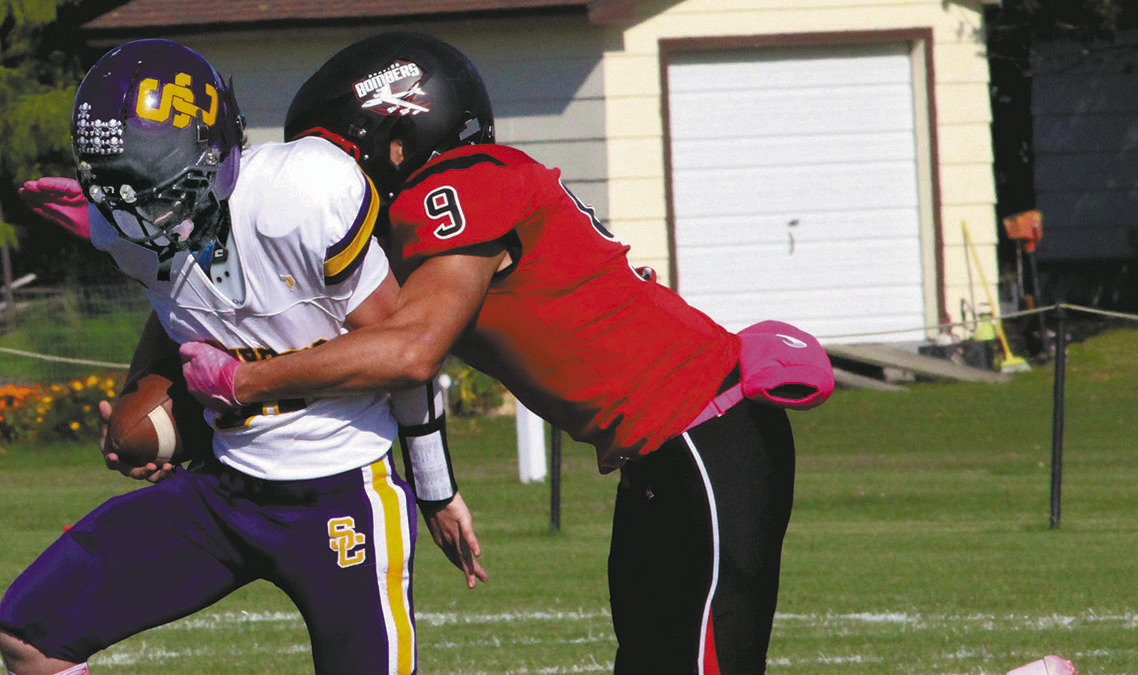 Bomber senior Mason Pollestad sacks the Clippers quarterback during Saturday's game in Drayton. Photo by Jamie Rarick