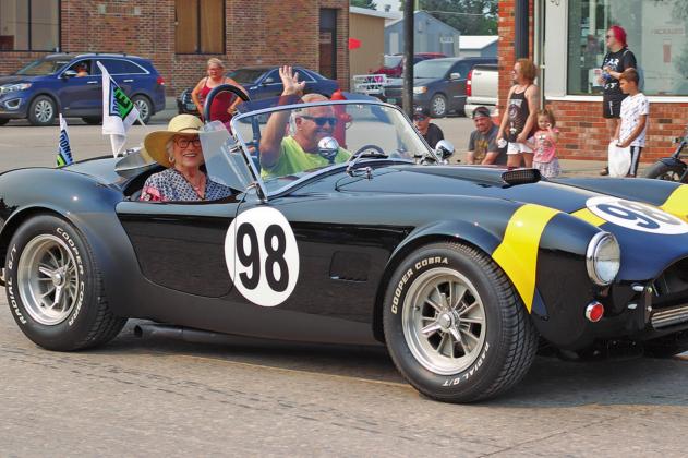 Bob Spencer and his Mother-in-Law Robin Brosseau promote organ donation during Saturday mornings parade flying the Donate Life flags on the race car that he brought with from Colorado. This car was also entered in the car show on Thursday evening winning first place. VNV Photo by Lesa Van Camp