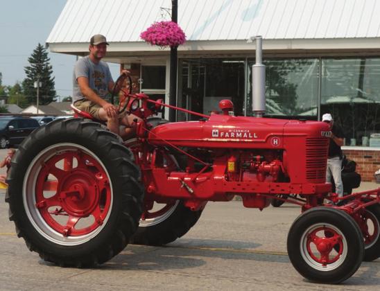 Blake Johnson drove Pastor Gary Johnson’s newly restored Farmall H in the RIVERFEST parade. VNV photo by Lyle Van Camp.