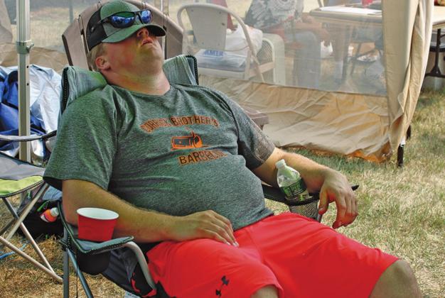 Cooking ribs good enough to win People’s Choice at Saturday’s Ribfest is very hard work as demonstrated by Randy Corrick Saturday afternoon. VNV Photo by Lesa Van Camp