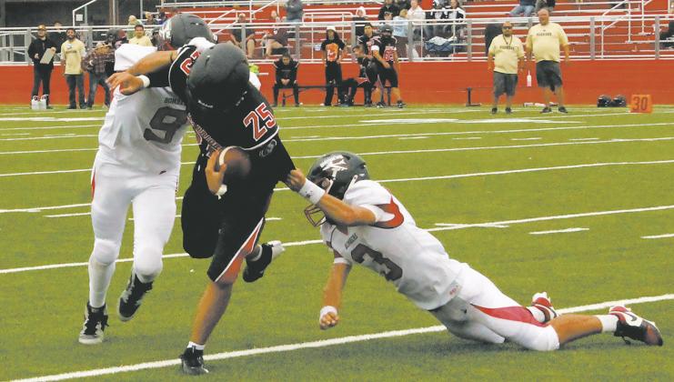 Mason Pollestad and Trenten Keena work together to bring down the White Shield quarterback. Photo by Jamie Rarick