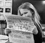 Arianna Nygaard reads the latest Kid Scoop News. Photo by Cecile Wehrman, The Journal.