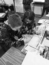 Connor Petersen and Ava Keysor, fourth graders at Kenmare Elementary, collaborate on activities in Kid Scoop News. Photo Terry Froseth, The Kenmare News.
