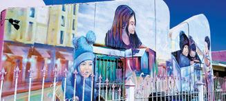 A mural titled “God loves everyone” photographed by Duane H.H. Lyon.