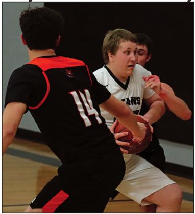 Lukas Pastorek tries to maintain possesion of the ball against Adre Carrier and another Tornado. VNV Photo by Lesa Van Camp