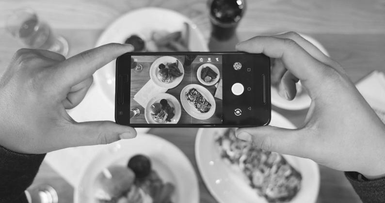 Using your phone while cooking or eating may create opportunities for viruses and bacteria to spread. (Photo by Eaters Collective on Unsplash)