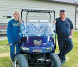 Amber Watts, who kept folks hydrated at the event, poses next to Nathan Brown. Nathan’s wife, Amber Brown, golfed in the tournament. Photo by Lauri Logsdon.