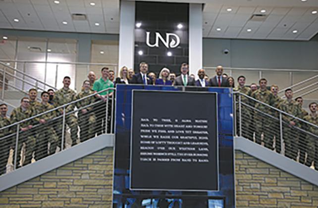 In this photo from April 2024, senior UND and Boeing leadership stand on a staircase in the Memorial Union flanked by UND ROTC members and other military students. Boeing was on campus to sign an agreement guaranteeing job interviews for graduating UND Reserve Officer Training Corps cadets, student veterans and active-duty students. UND archival photo.