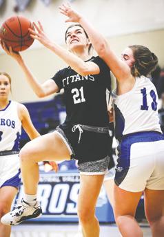 Freshman Elizabeth Fedje goes up for a basket defended by H-CV's Megan Ensign Friday. Photo courtesy of Corey Erickson, Hillsboro Banner.