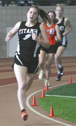 Greta Burrell and Alyssa Hoyles sandwich another runner in the Girls 300.
