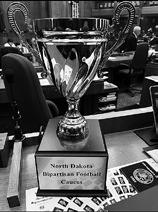 A trophy on the desk of Rep. Matthew Ruby, R-Minot, represents bragging rights for winning a bipartisan fantasy football league.