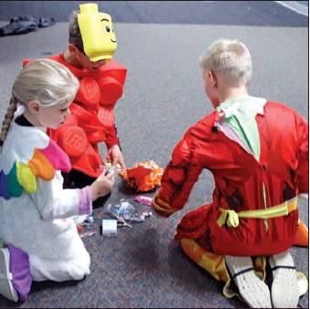 Pictured left: Among the cutes costumes were this group of Mac and Cheese. Pictured standing are left to right Jocelyn Vold, Landon Maple, and newborn Mac Vold sleeping away through all the chaos of the carnival. Pictured above: Checking out all the goodies during the Halloween Carnival Sunday afternoon. Pictured far right: Connor Corrick showed off his catch at the Halloween Carnival held in the Drayton Public School Gym on Sunday afternoon. VNV Photos by Lesa Van Camp