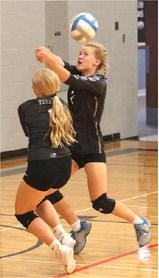 Reese Ferring and Alyssa Hoyles try to save a volley in the Drayton Gym last Thursday. Photo by Lyle Van Camp.