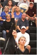 Elizabeth Fedje puts down a kill attempt in action against HCV last Thursday in Drayton. Photo by Lyle Van Camp.