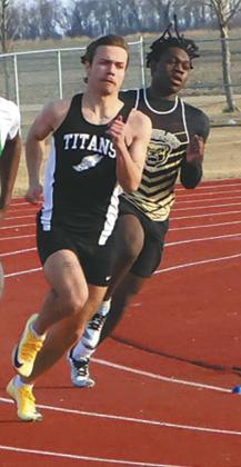 Fighting through the wind and cold, sprinters, including DVE junior Trenten Keena, rounded the track during the Mens 200m dash. Keena earned a 7th-place finish in the competitive event. Photo by Jamie Rarick