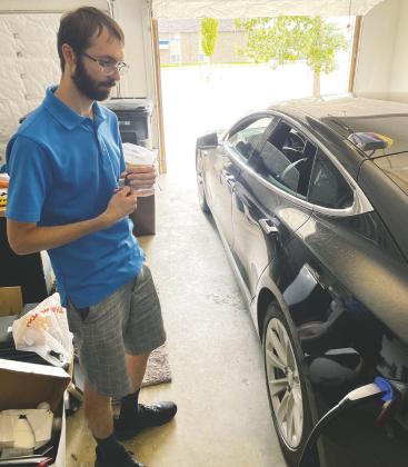 Like most days, Brian Kopp gets around Dickinson on one charge per day and plugs in again at home in the evening, pictured here demonstrating in his garage on Aug. 25, 2022. Photo Michael Standaert.