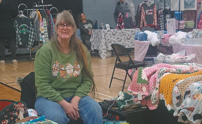 Elizabeth Wallace finds healing in creating her one-of-a-kind blankets. Pictured at Drayton's Old Fashioned Christmas vendor event. Photo by Christine Jensen