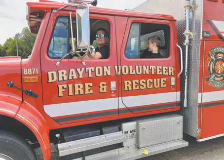 Kids enjoyed firetruck rides throughout Saturday since it was a bit too cool for water games. Photo by Duane H.H. Lyon.