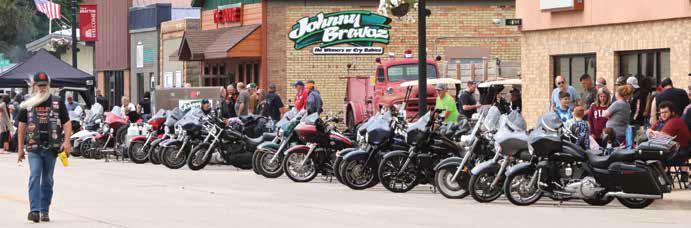 Randy Hills walks past the bikes just before the start of the Tom Landowski memorial ride on Saturday. Photo by Lyle Van Camp.