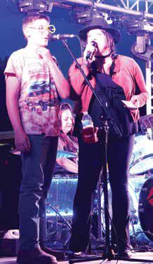 Ethan Sherrill got to sing with the band at the street dance. Photo by Lyle Van Camp.