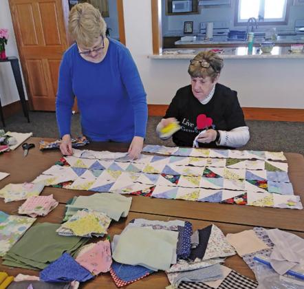 Kris Heine and Ann Twamley assembling pieces for a quilt top for their mission project. Photo submitted by Laura Hammond