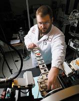 EERC materials scientist Blaise Mibeck loads samples for testing in a system used for evaluating critical mineral concentrations.