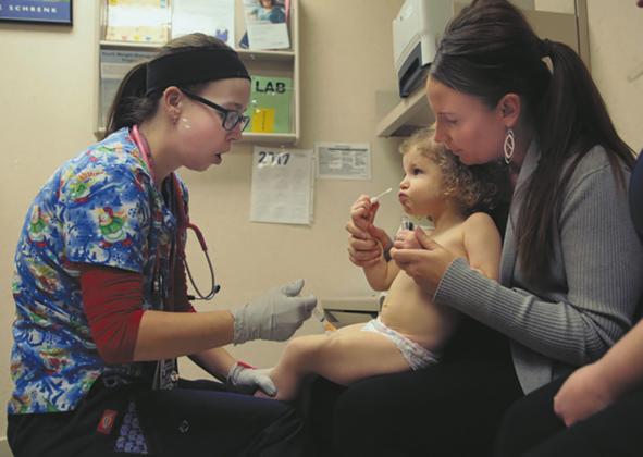 Nurse Julianna Emanuel administers a hepatitis A vaccine shot at the Sanford Children's Clinic in Fargo. Photo by Dave Wallis, courtesy of The Forum.