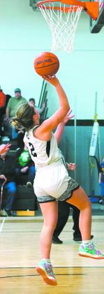 Brooke Gullickson goes for a layup in play against the Mustangs. Photo by Larry Stokke.