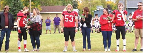 The Bombers Seniors and their parents were introduced at the start of the New Town game. From the left; Juan and Jessie Navarro and Gavin Ryan; Bryce Wimpfheimer and his mother Kristi Wimpfheimer; Maggie Vold, Grant Vold, and Matt Vold.
