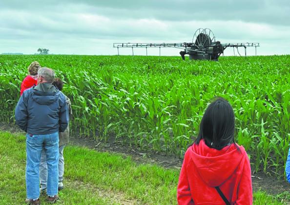 Attendees watch the 360 Rain autonomous irrigation applicator in action in SE North Dakota as part of the North Dakota Water Education Foundation 2025 Water Tour series. Photo provided by ND AgTech Engine.