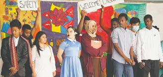 High school students from Grand Forks Public Schools perform a play for World Refugee Day on June 18, 2022 at the Town Square Farmers Market, marking the theme 'Whoever. Wherever. Whenever. Everyone has the right to seek safety.' Photo credit: Mark Broden, courtesy of the Global Friends Coalition.