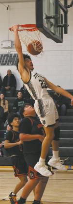 Sprinting down the court, DVE's Mason Pollestad wows the crowd with an impressive dunk. Photo by Jamie Rarick