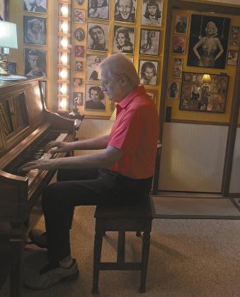 Brosseau in his music room surround by Hollywood photos. Photo by Christine Jensen.