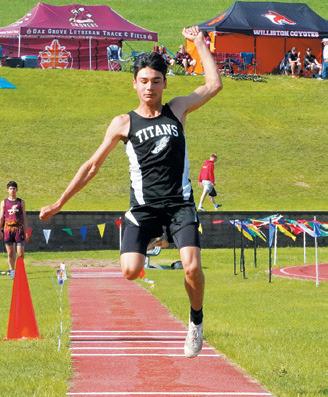 Ashton Knutson soars through the triple jump.