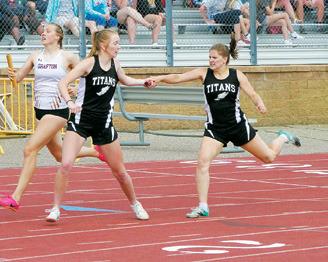 Greta Burrell hands off to Easton Larson in the 4X400 meter relay.