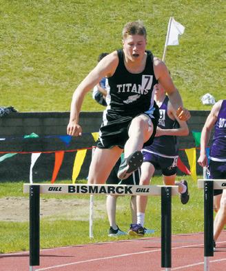 Andrew Myrdal leaps over a hurdle at the state meet.
