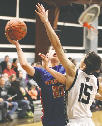 Jayse Gullickson tries to stop Benson County's Gunnar Larson. Photo by Lyle Van Camp.