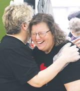 Barbie Steenerson and Meredith Gozdal share an ‘it will be alright moment’ before the benefit begins on Saturday. Photo by Lyle Van Camp.