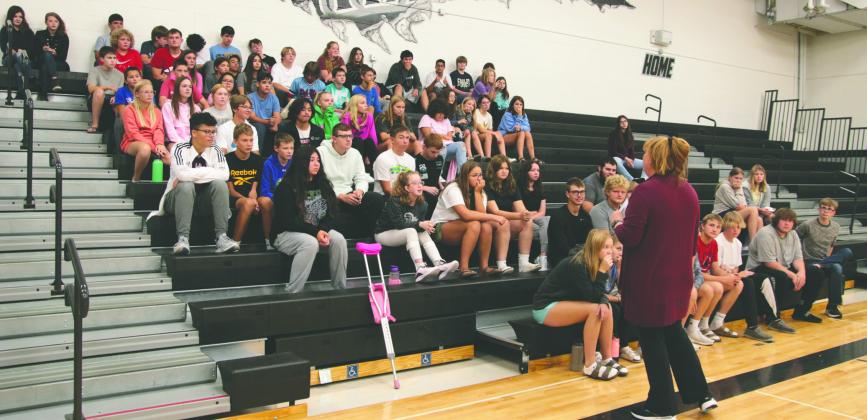 Dr. Peterson visits with students at the August 31 assembly. The Junior High and Senior High students hear about the team program for the first time at an assembly on August 31.