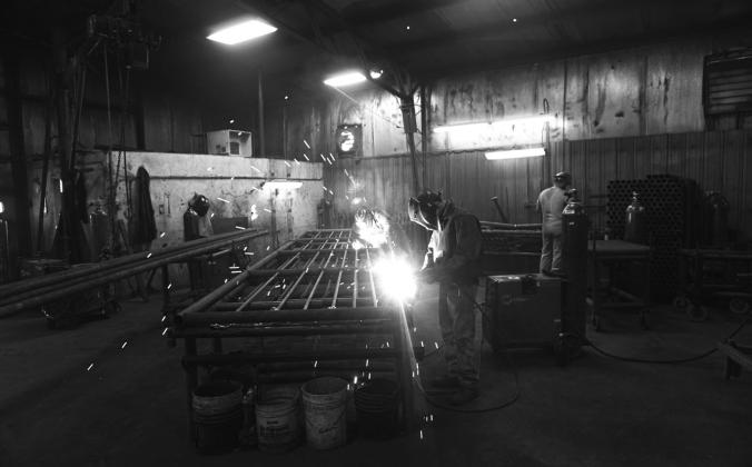 Workers at Double J Manufacturing &amp;amp; Repair welding fencing and gates at the company shop near Gackle, North Dakota on Oct. 14, 2022. Photo by Michael Standaert