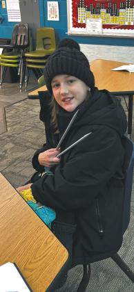 4th grader, DeeDee Manley showing off her knitting needles that were originally owned by her great grandmother. Photo by Andrea Johnston